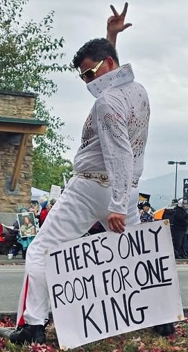 Elvis dancing with There's only room for one king sign